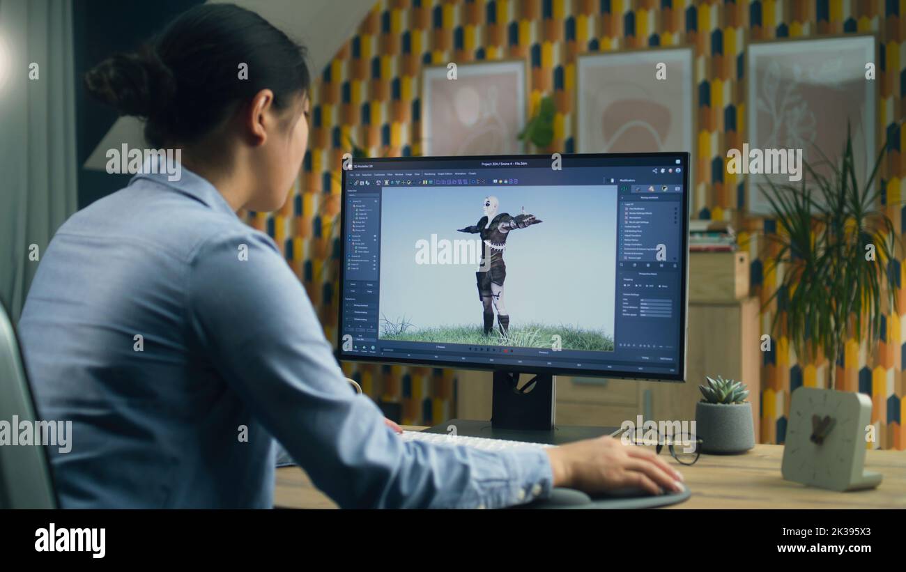 Diseñadora 3D asiática haciendo animación para el personaje de videojuegos utilizando un ordenador moderno con software para la creación de proyectos de modelado en 3D Foto de stock