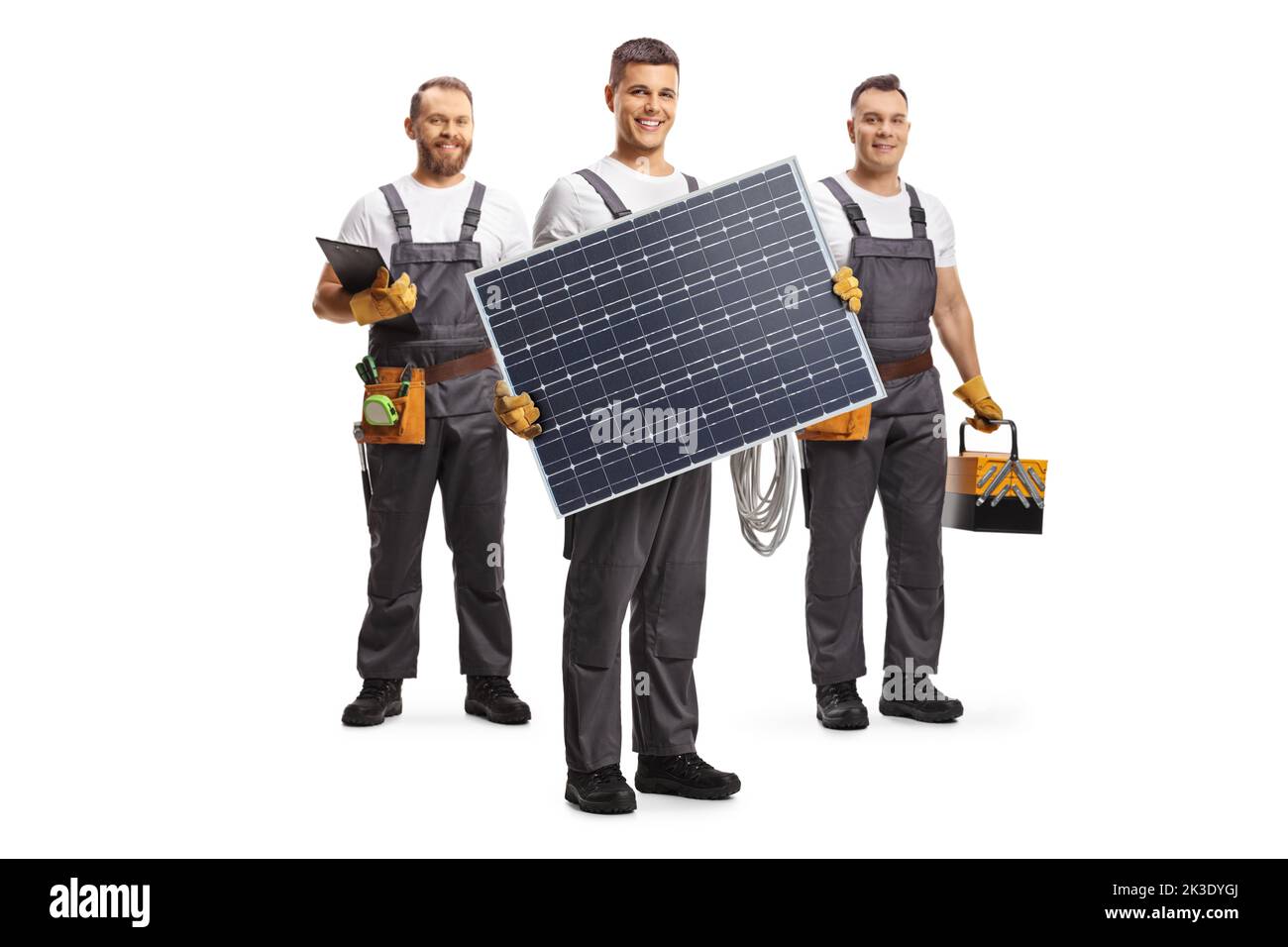 Equipo de técnicos con panel solar y herramientas aisladas sobre fondo blanco Foto de stock