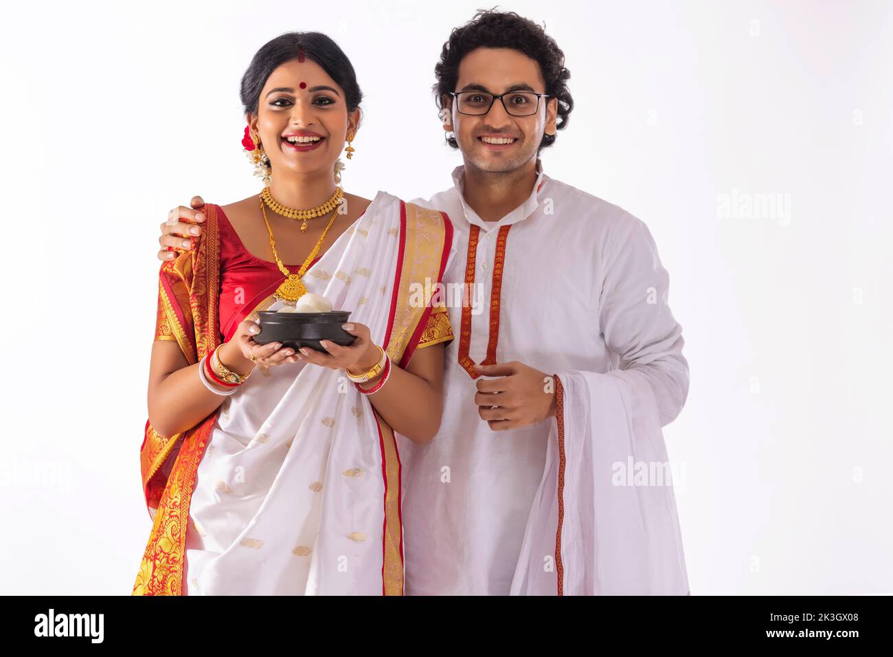 Retrato de la feliz pareja bengalí junto con rosogolla handi Foto de stock