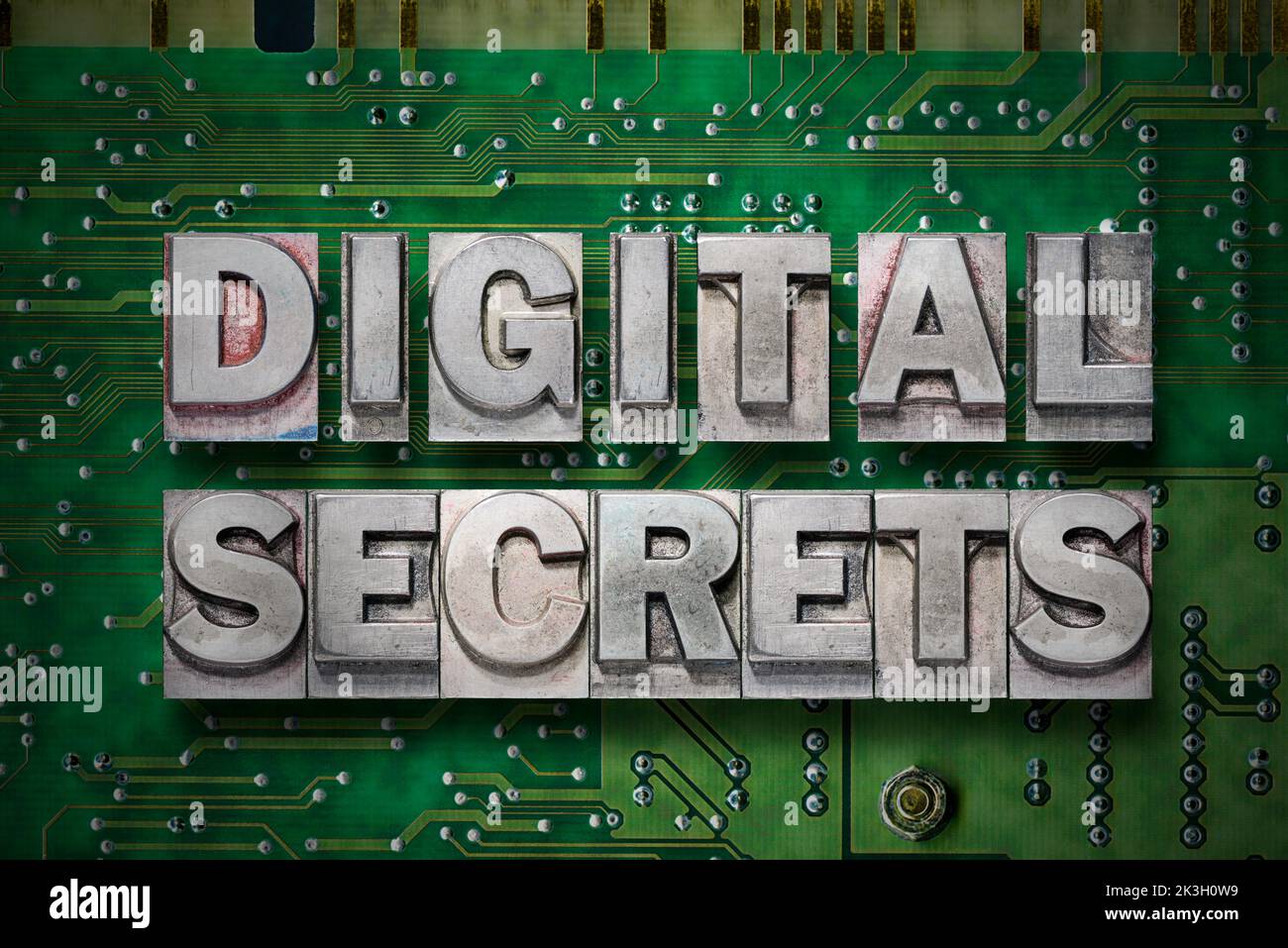la frase de los secretos digitales hecha de los bloques metalizados de la tipografía en el fondo de la placa de pc Foto de stock