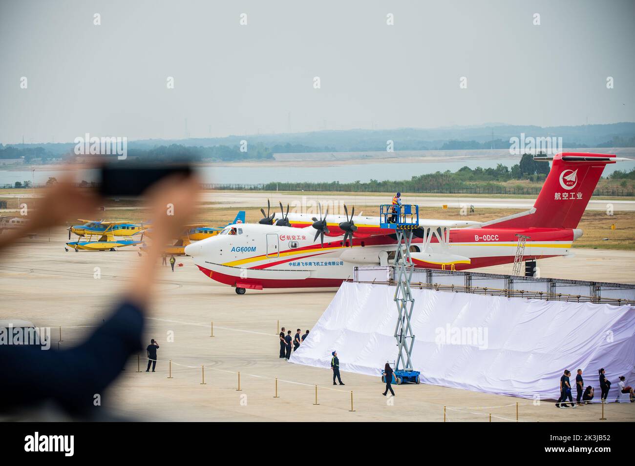Jingmen, provincia china de Hubei. 27th de Sep de 2022. Un visitante toma una fotografía de un avión de combate contra incendios AG600M en Jingmen, en la provincia de Hubei, en China central, el 27 de septiembre de 2022. Con el nombre en código Kunlong, la familia de aviones anfibio grandes de AG600 se considera equipo aeronáutico clave para el sistema de rescate de emergencia de China. Fue desarrollado por la Aviation Industry Corporation of China (AVIC), el fabricante de aviones líder del país, para satisfacer las necesidades de las misiones de combate de incendios y rescate marítimo, así como otras operaciones críticas de rescate de emergencia. Crédito: Wu Zhizun/Xinhua/Alamy Live News Foto de stock