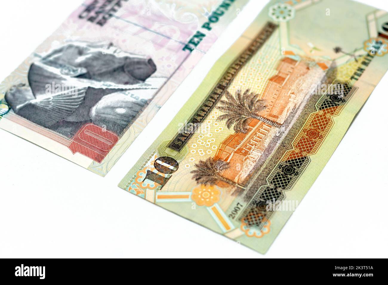Un billete de diez riyales de Arabia Saudita con billete de diez libras egipcias aislado sobre un fondo blanco Foto de stock