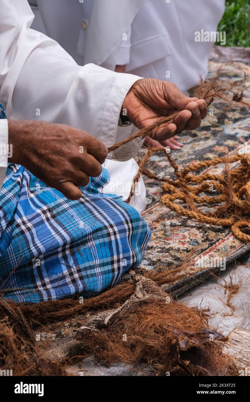 Afro-árabe de Abu Dhabi Fabricación de cuerda de fibra de coco para su uso en la fabricación de redes de pesca tradicionales. Foto de stock