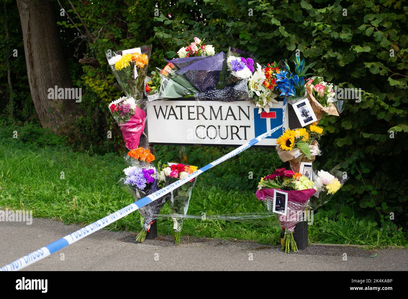 Cippenham, Slough, Berkshire, Reino Unido. 3rd de octubre de 2022. Tributos florales en la escena. La policía de Thames Valley ha iniciado una investigación de asesinato tras un incidente en Slough. Alrededor de las 8,50pm de la tarde de ayer, 2nd de octubre, 2022 oficiales recibieron un informe que indicaba que un hombre había sido gravemente herido en el Tribunal Waterman, Cippenham. Los oficiales asistieron al lugar donde se comprobó que un hombre de 21 años había sufrido una colisión con su bicicleta con un coche, supuestamente un Volkswagen Golf de color negro en Earls Lane. Crédito: Maureen McLean/Alamy Live News Foto de stock