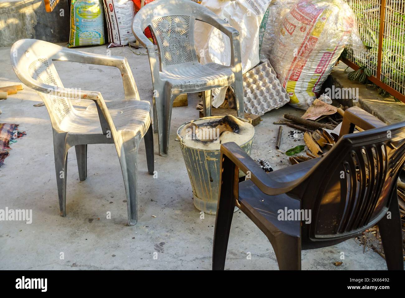 enero 29th 2021, Dehradun Uttarakhand India. Sillas vacías alrededor de una estufa de fuego tradicional durante los inviernos en el patio trasero. Foto de stock