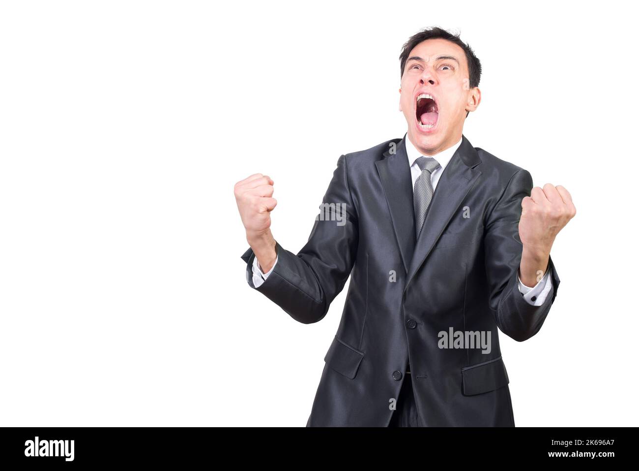 Hombre histérico en traje formal gritando en el estudio Foto de stock