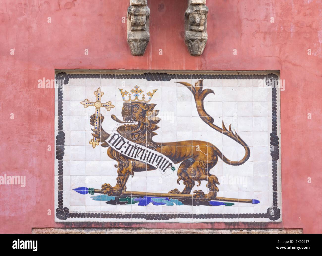 Un azulejo pintado con el escudo de armas con un león y una corona en