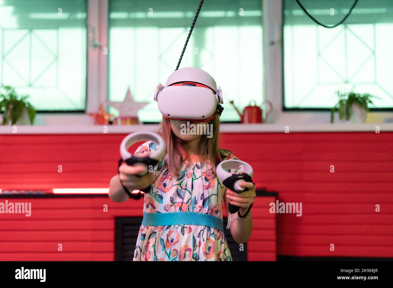 Juego vr y jugadora de realidad virtual para niños de ocho años, diversión  jugando en un videojuego de simulación futurista con gafas 3d y joysticks  en entretenimiento, tecnología de innovación en la