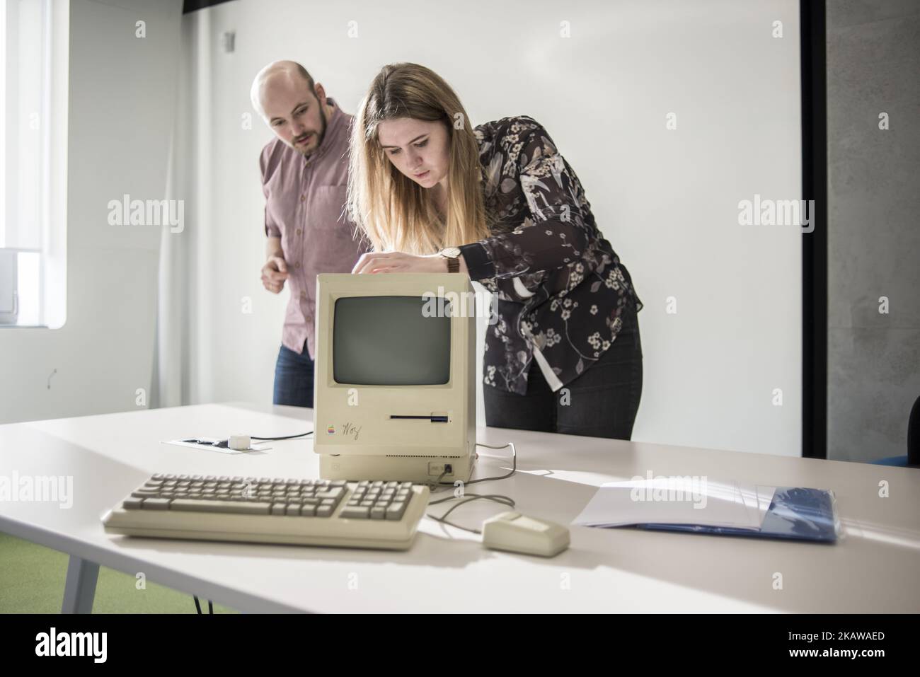 Los miembros del personal muestran Macintosh 128K, firmado por Steve Wozniak, fecha de lanzamiento el 1984 de enero, en el Museo Ucraniano de Manzanas MacPaw en Kiev, Ucrania el 26 de enero de 2017. El desarrollador ucraniano MacPaw ha abierto el museo de hardware de Apple en la oficina de la compañía en Kiev. La colección tiene más de 70 modelos originales de Macintosh fechados entre 1981 y 2017. (Foto de Oleksandr Rupeta/NurPhoto) Foto de stock