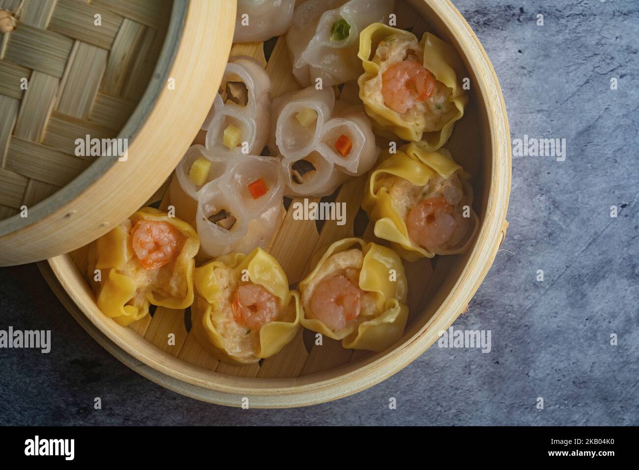 Dim Sum mezcla al vapor en bambú basket.Large variedad de pequeños platos  chinos que se disfrutan tradicionalmente en los restaurantes para el brunch  Fotografía de stock - Alamy