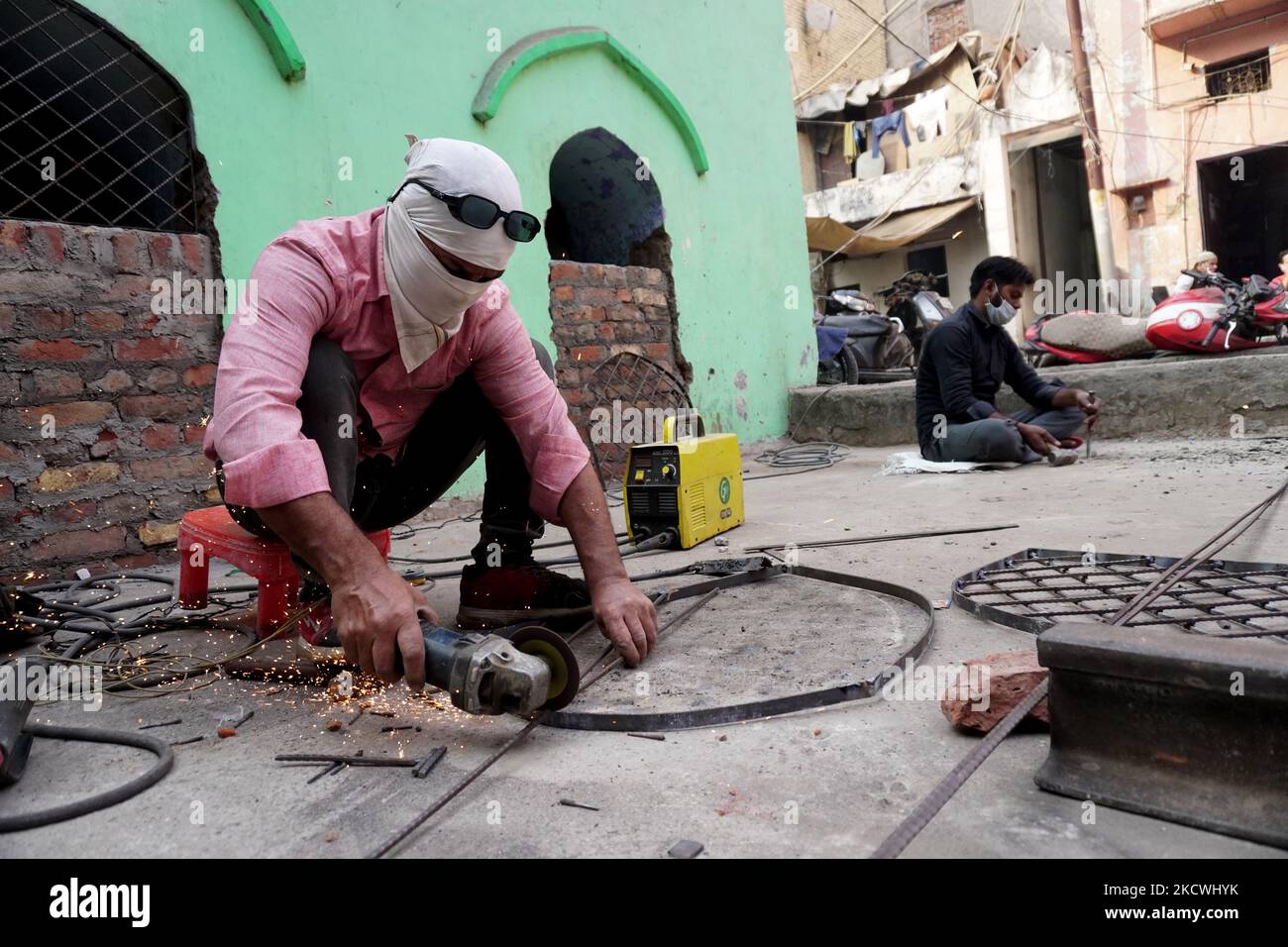 Un trabajador corta barras de hierro para hacer un marco fuera de un taller  en Nueva Delhi, India el 25 de noviembre de 2021. El Banco de Reserva de la  India prevé