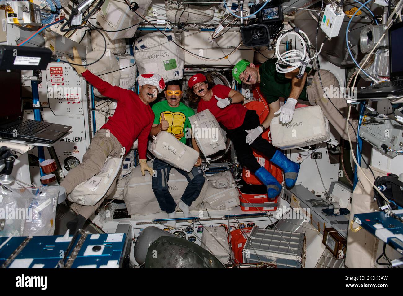 ISS - 31 de octubre de 2022 - Cuatro Ingenieros de Vuelo de la Expedición 68 de la ISS se visten como personajes populares de videojuegos y dibujos animados para celebrar la diversión de Halloween Foto de stock