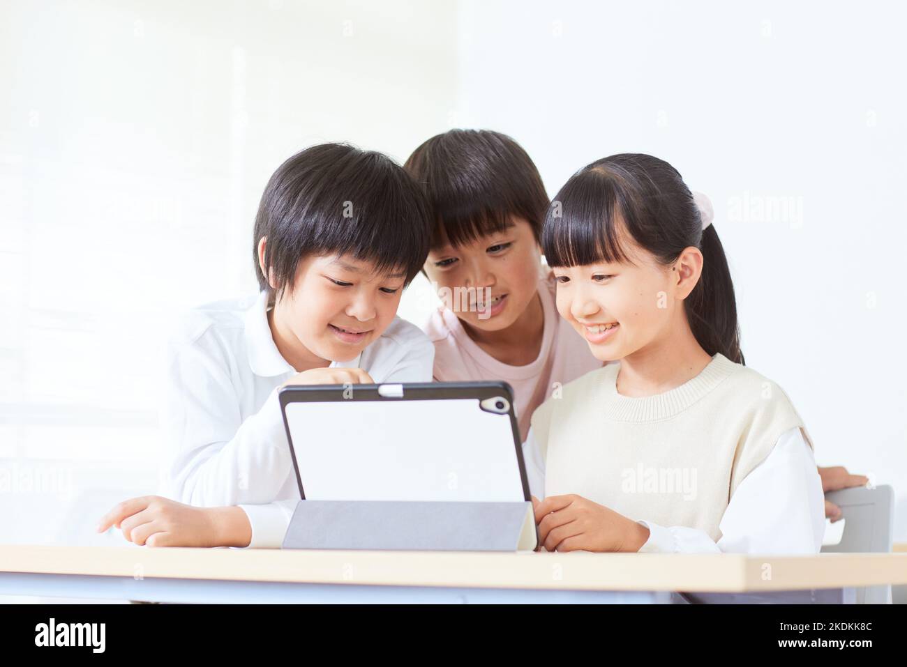 Niños japoneses usando la tableta Foto de stock