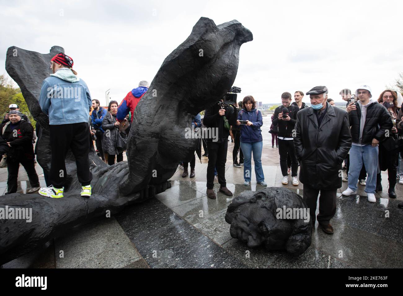 La gente mira el monumento soviético caído a una amistad entre las