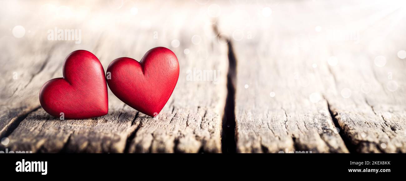 Corazón hecho de hojas de libros en luces, amor y concepto de san valentín  en una mesa de madera