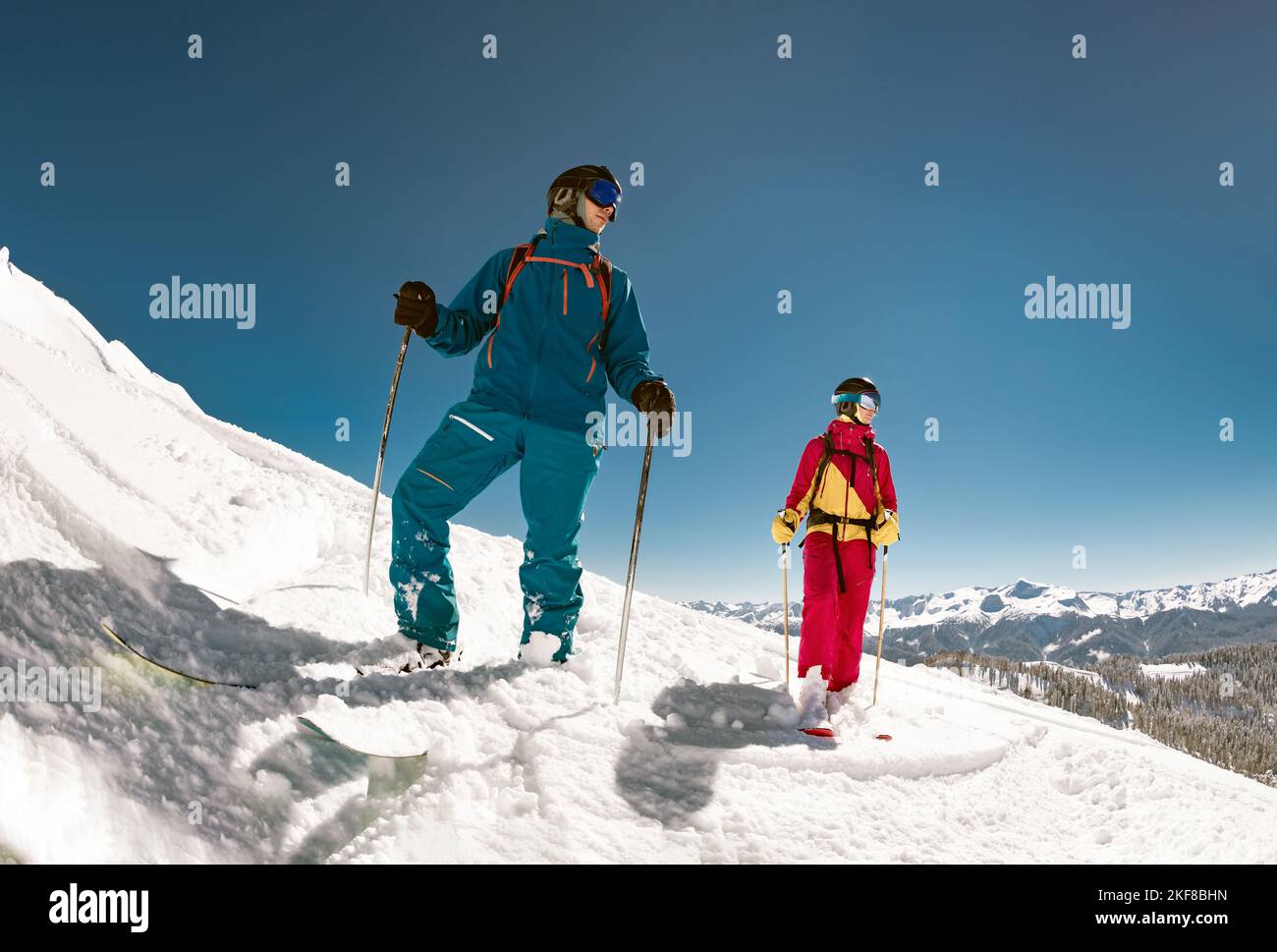 Dos jóvenes esquiadores están de pie en la pista de esquí. Foto de stock