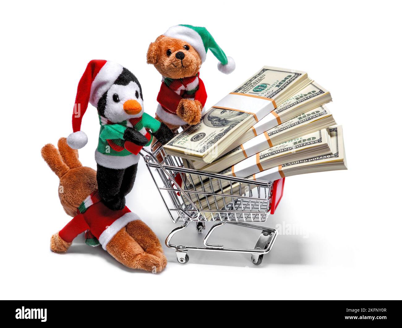 Ayudantes de Santa con un carro de compras lleno de dinero. Divertido concepto de Navidad Foto de stock