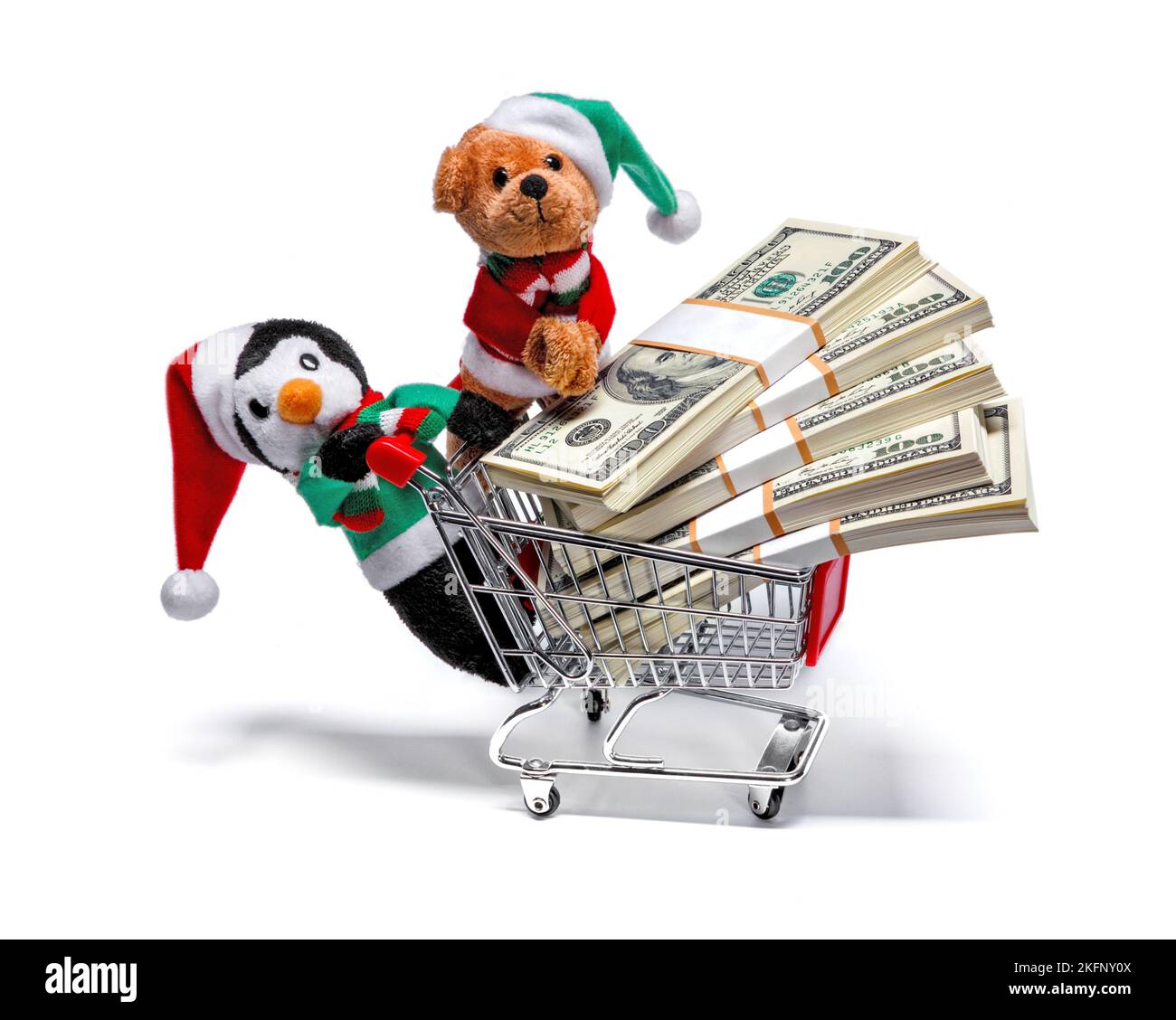 Ayudantes de Santa con un carro de compras lleno de dinero. Divertido concepto de Navidad Foto de stock