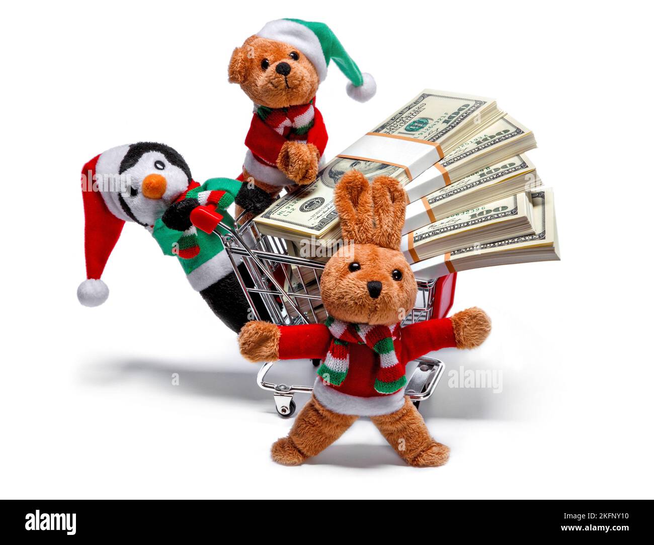 Ayudantes de Santa con un carro de compras lleno de dinero. Divertido concepto de Navidad Foto de stock
