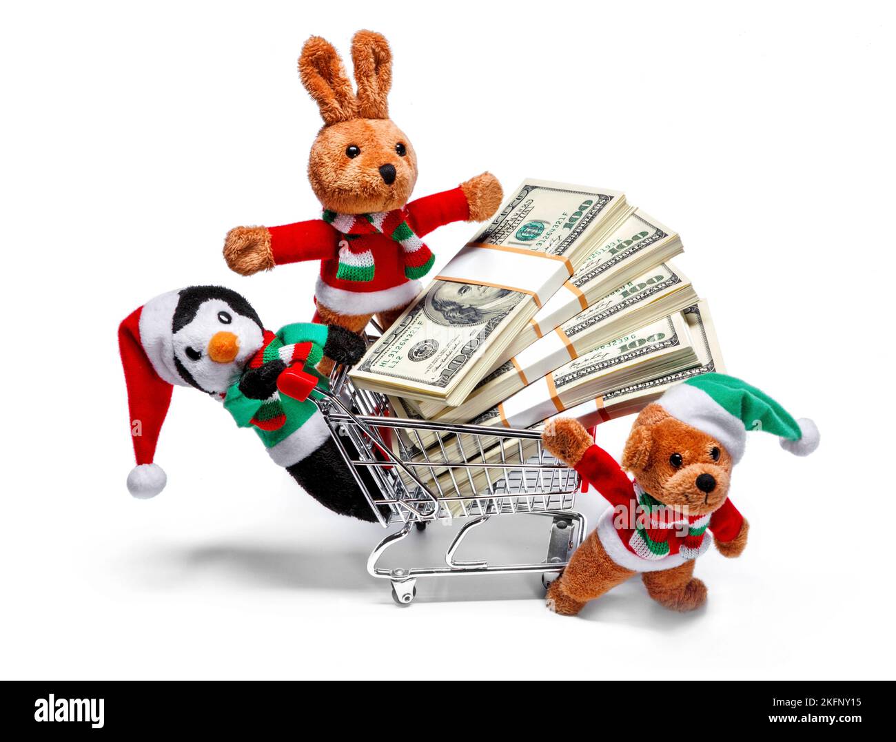 Ayudantes de Santa con un carro de compras lleno de dinero. Divertido concepto de Navidad Foto de stock