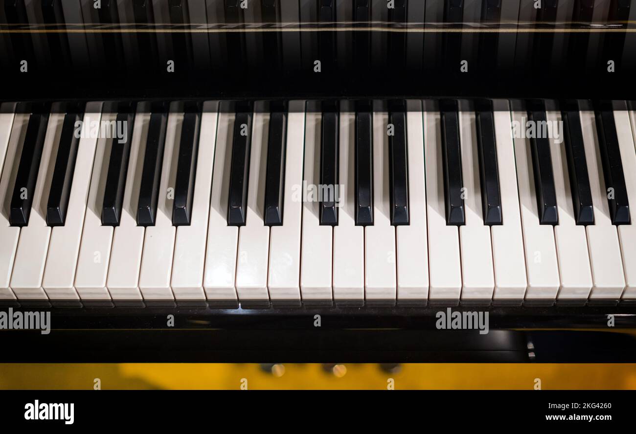 Desde arriba, teclas blancas y negras de piano instaladas en el escenario durante un concierto en el teatro Foto de stock