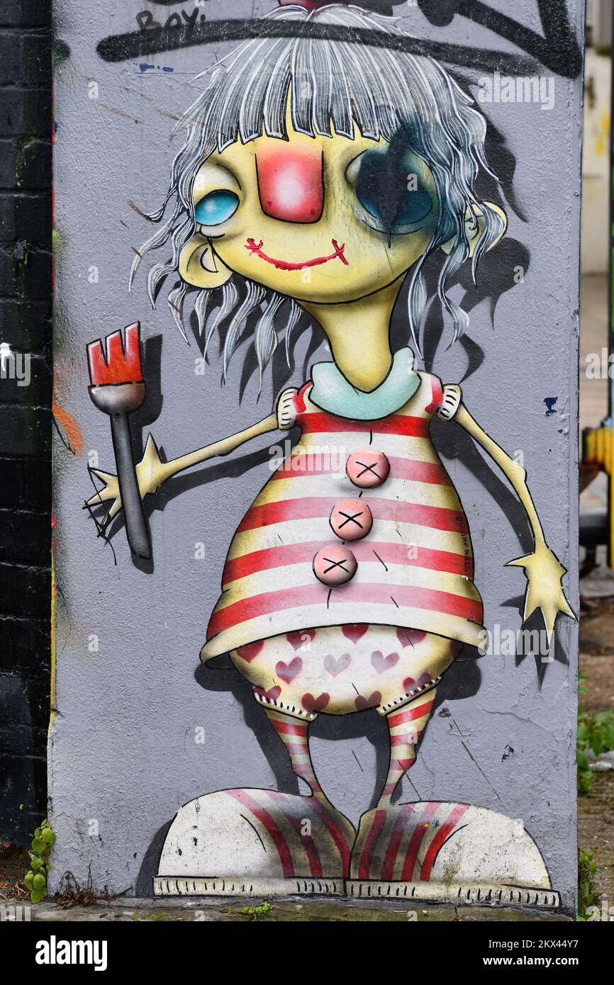 Artista femenina de arte callejero en camisa de rayas rojas y blancas, Shoreditch, Londres Foto de stock