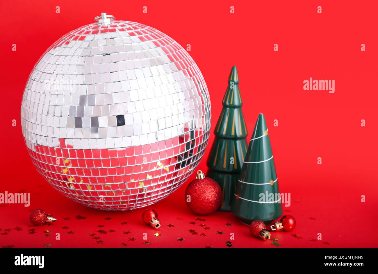 Bola disco con juguetes de Navidad sobre fondo rojo Fotografía de stock -  Alamy