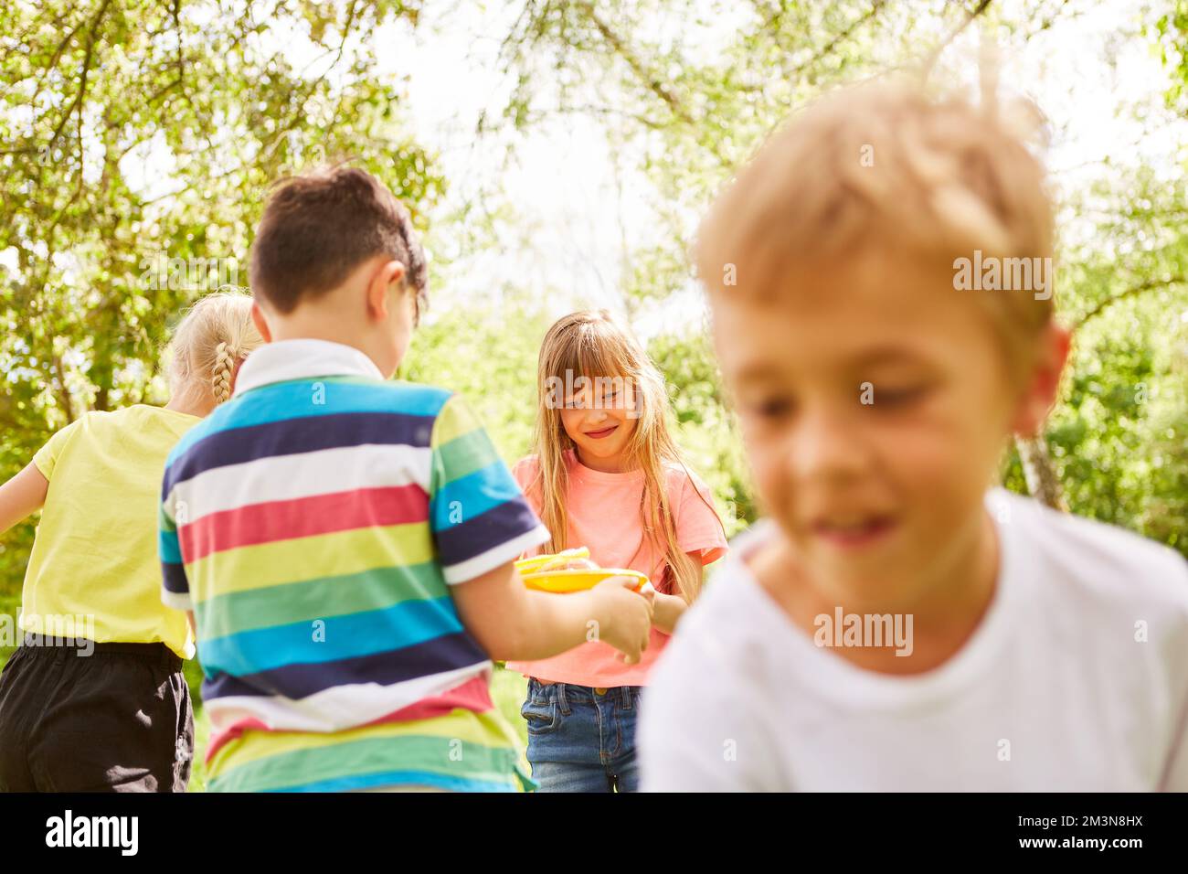 Niños Multirraciales Mirando La Varita De Burbujas De Pie En El Jardín Durante Las Vacaciones 2994