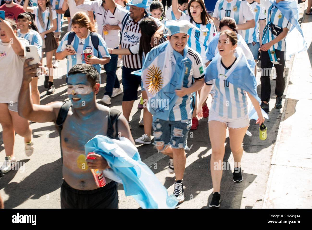 Los aficionados caminan en Buenos Aires, Argentina caminando hacia el Obelisco para celebrar la victoria de su equipo nacional en la Copa Mundial de la FIFA 2022 Foto de stock