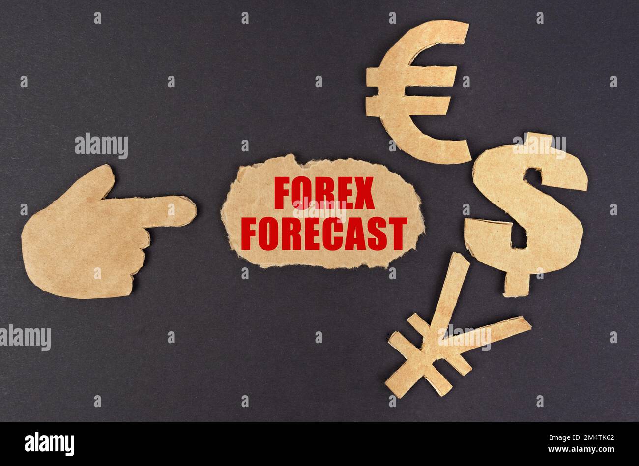 Concepto de economía y finanzas. En una superficie negra, una figura de una mano, símbolos de dinero y cartón rasgado con la inscripción - Forex Forecast Foto de stock