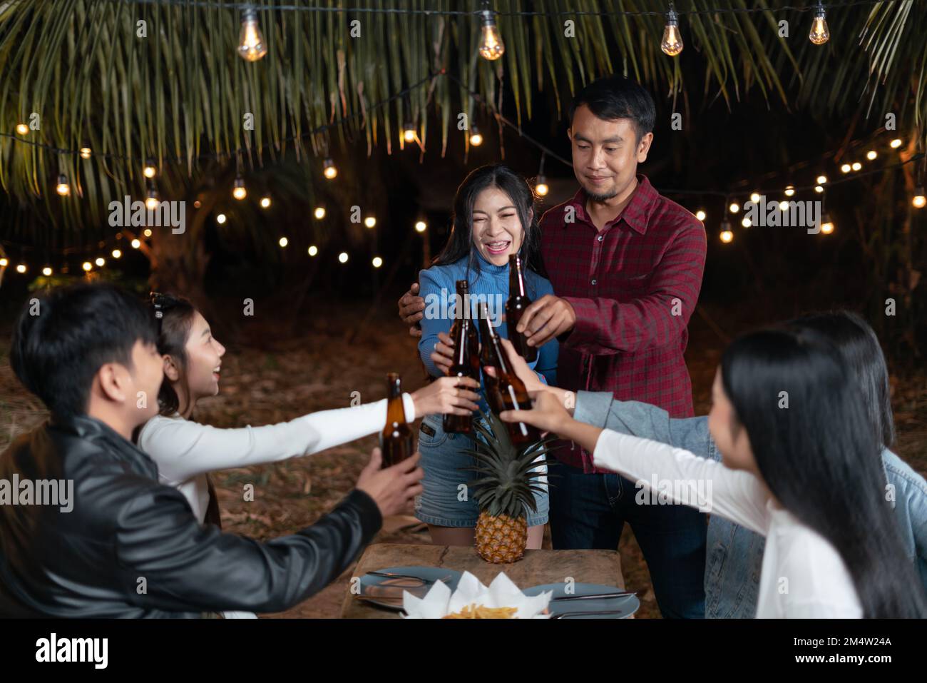 Parejas jóvenes y amigos disfrutan de una fiesta feliz bebiendo cerveza juntos. Foto de stock