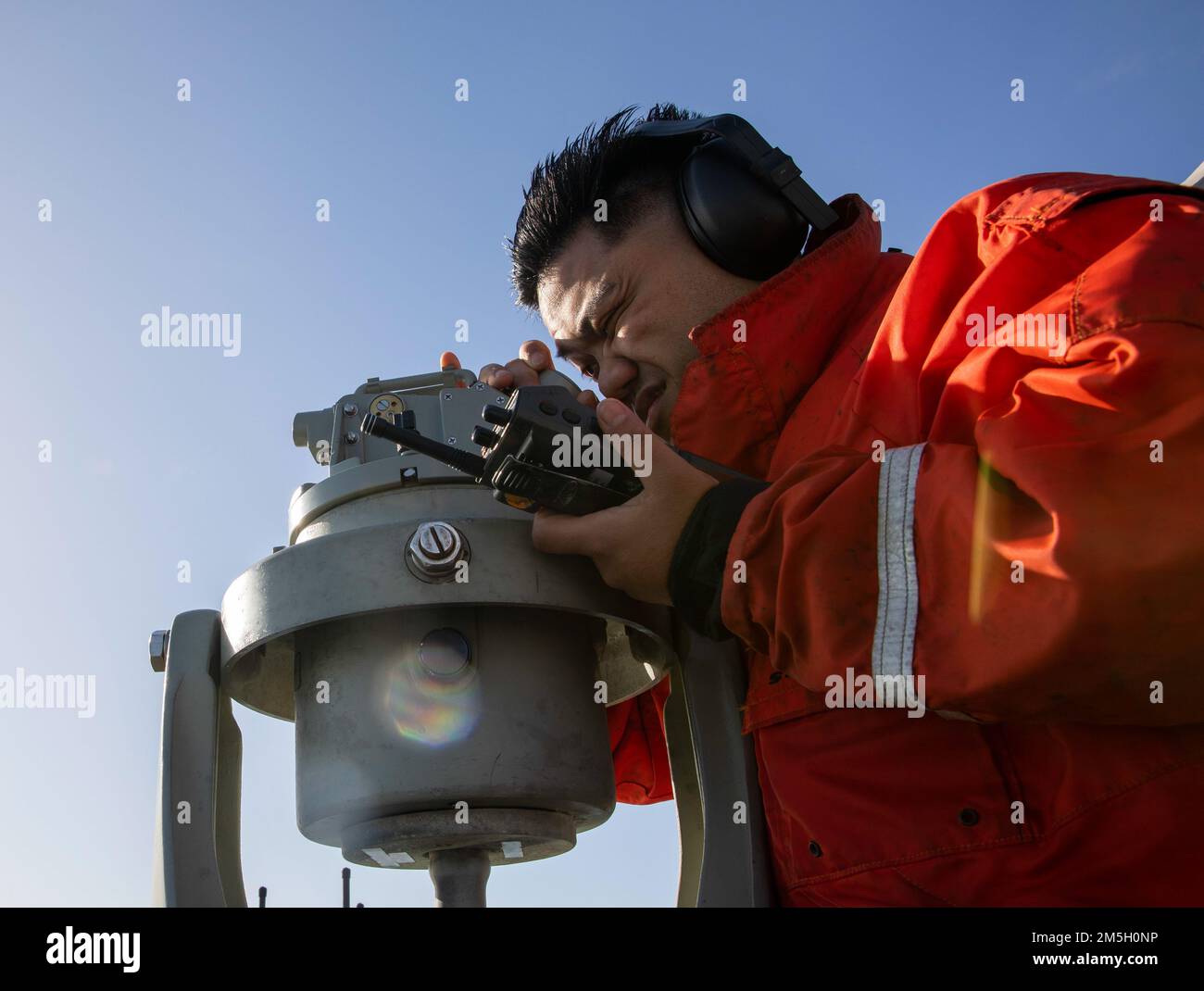220318-N-XK047-2067 SAN FRANCISCO BAY (18 de marzo de 2022) – El Cuarteto  Clase 3rd Ian Evangelista mira a través de una alidade mientras usa una  radio de mano a bordo del buque