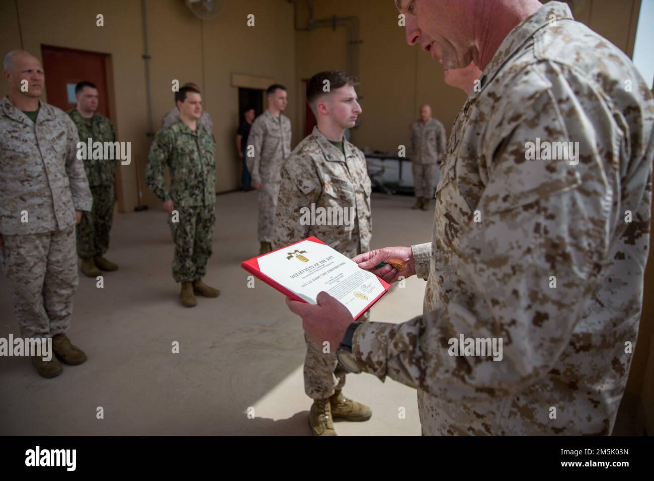EE.UU Blake W. Roberts, secretario legal de la Brigada Expedicionaria de Marines 51/5th de la Fuerza de Tarea, llama la atención mientras que el sargento mayor Steven L. Lunsford, sargento mayor de las Fuerzas del Cuerpo de Marines, Comando Central (MARCENT) lee una citación durante una ceremonia de premiación a bordo de la Actividad de Apoyo Naval de Bahréin, marzo de 21. Roberts fue galardonado con la Medalla de Logros de la Marina y el Cuerpo de Marines por ser seleccionado como el Marín del Año de MARCENT. Foto de stock