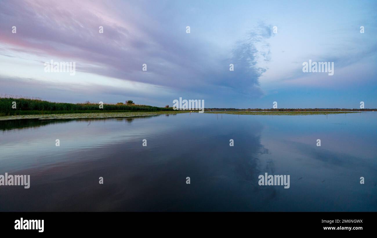 Amanecer con reflejos en el delta del Danubio en Rumania Foto de stock