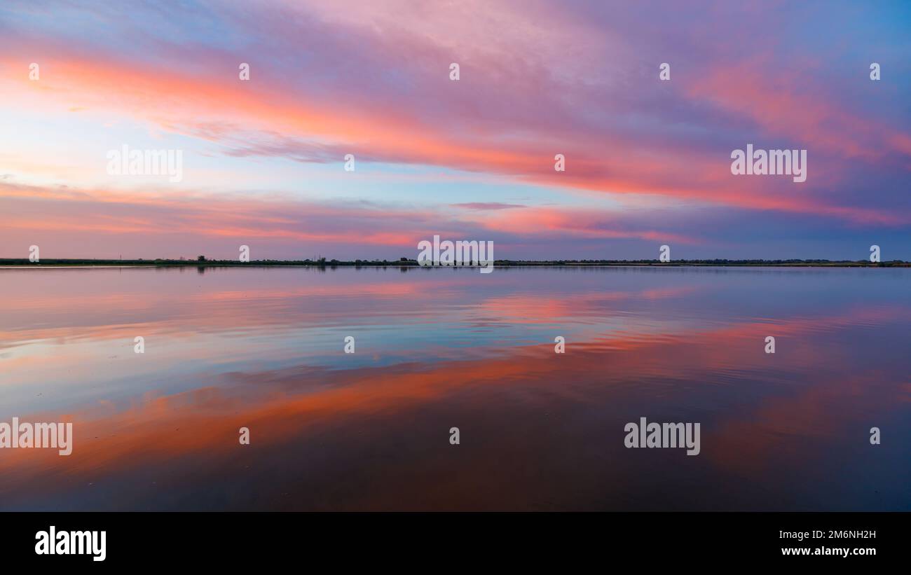 Amanecer con reflejos en el delta del Danubio en Rumania Foto de stock