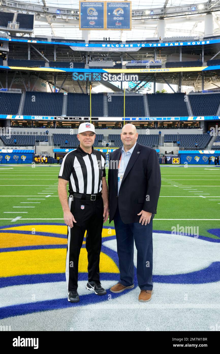 Referee Brad Rogers, left stands with replay official Durwood