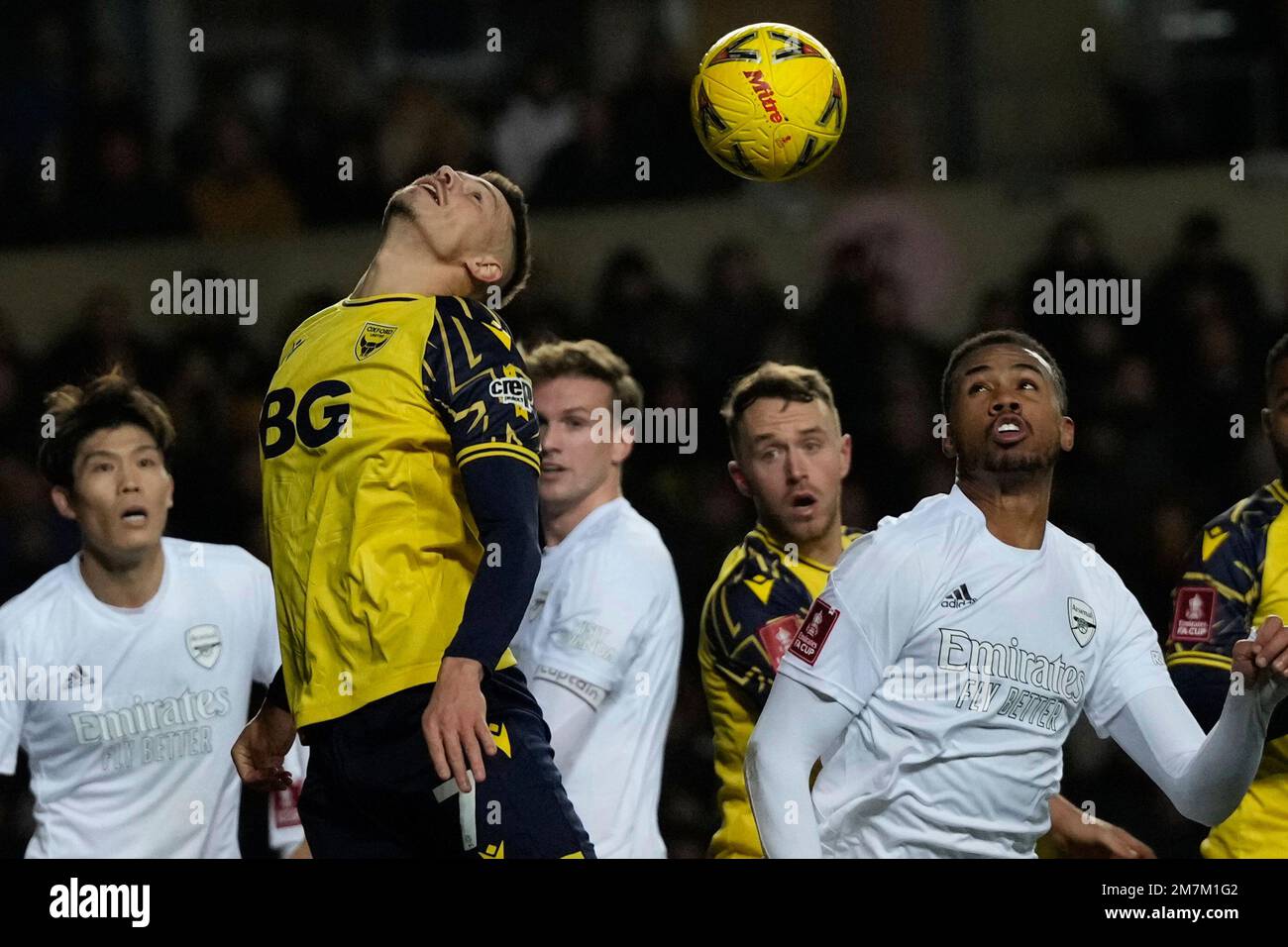Oxford's Billy Bodin, left, heads the ball during the English FA Cup