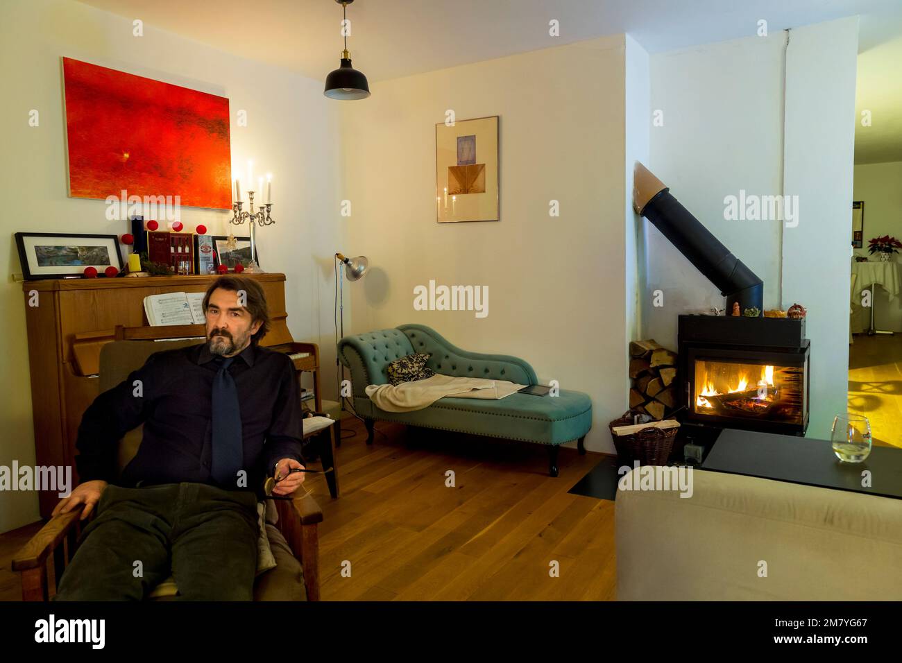 hombre de mediana edad sentado en silla en casa Foto de stock