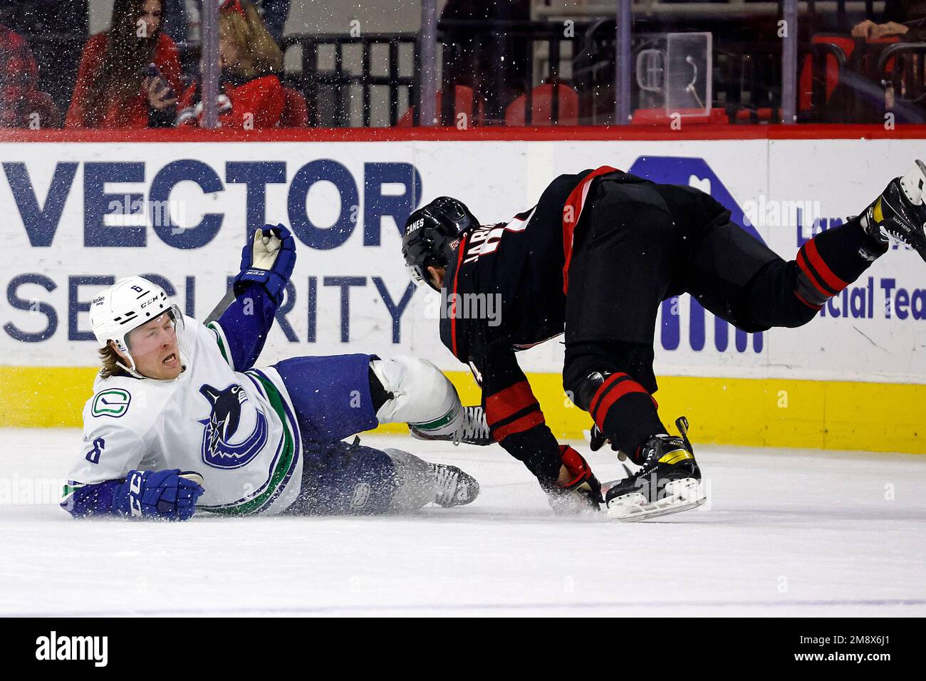 Vancouver Canucks' Brock Boeser (6) collides with Carolina Hurricanes