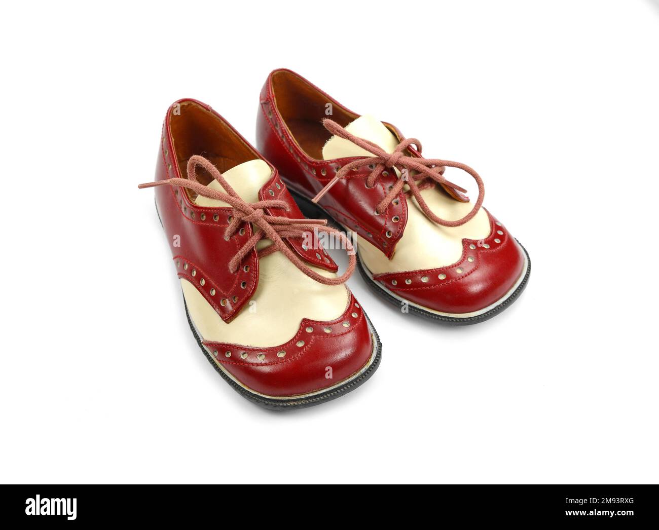 vintage zapatos rojos y blancos un niño pequeño aislado en blanco Fotografía de -