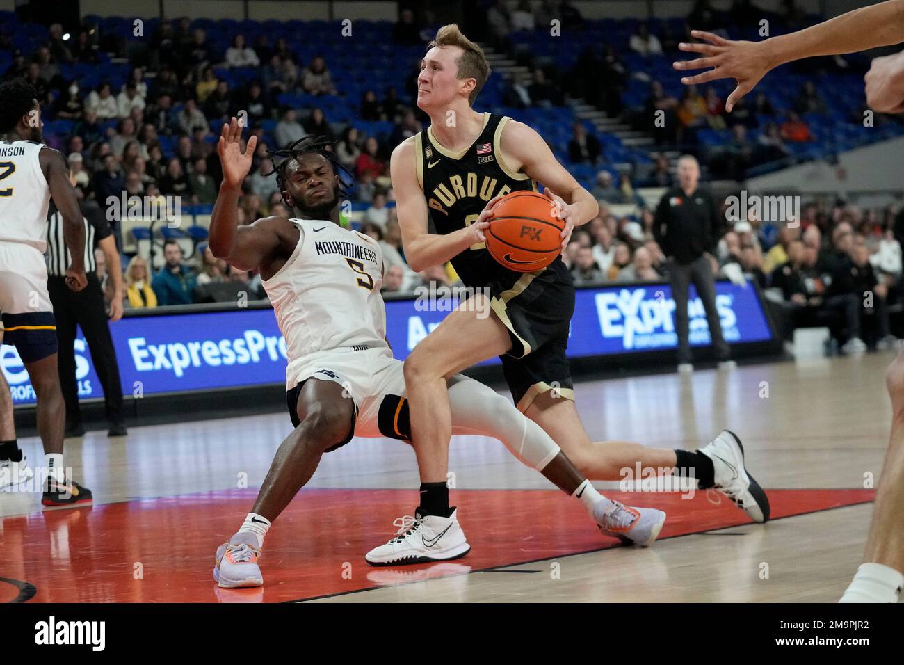 West Virginia guard Joe Toussaint (5) takes a charge from Purdue guard