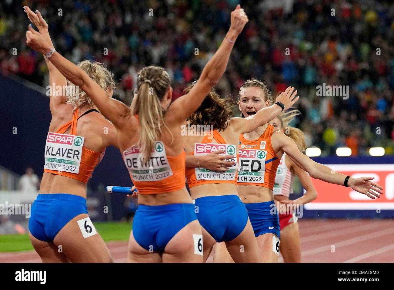 Femke Bol, of the Netherlands, right, celebrates with her team after