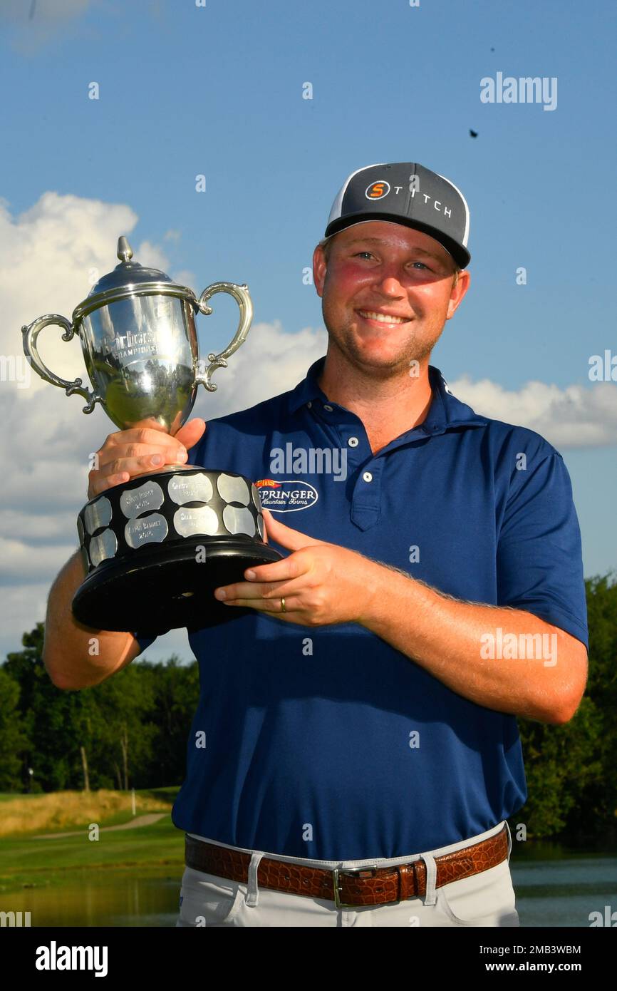 Trey Mullinax holds the trophy after winning the Barbasol Championship
