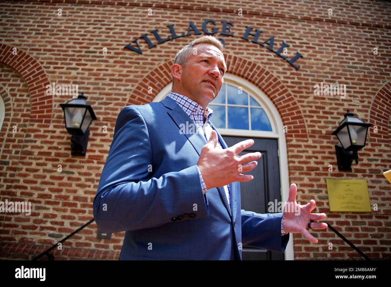 New Albany, Ohio Mayor Sloan Spalding talks with a reporter outside New