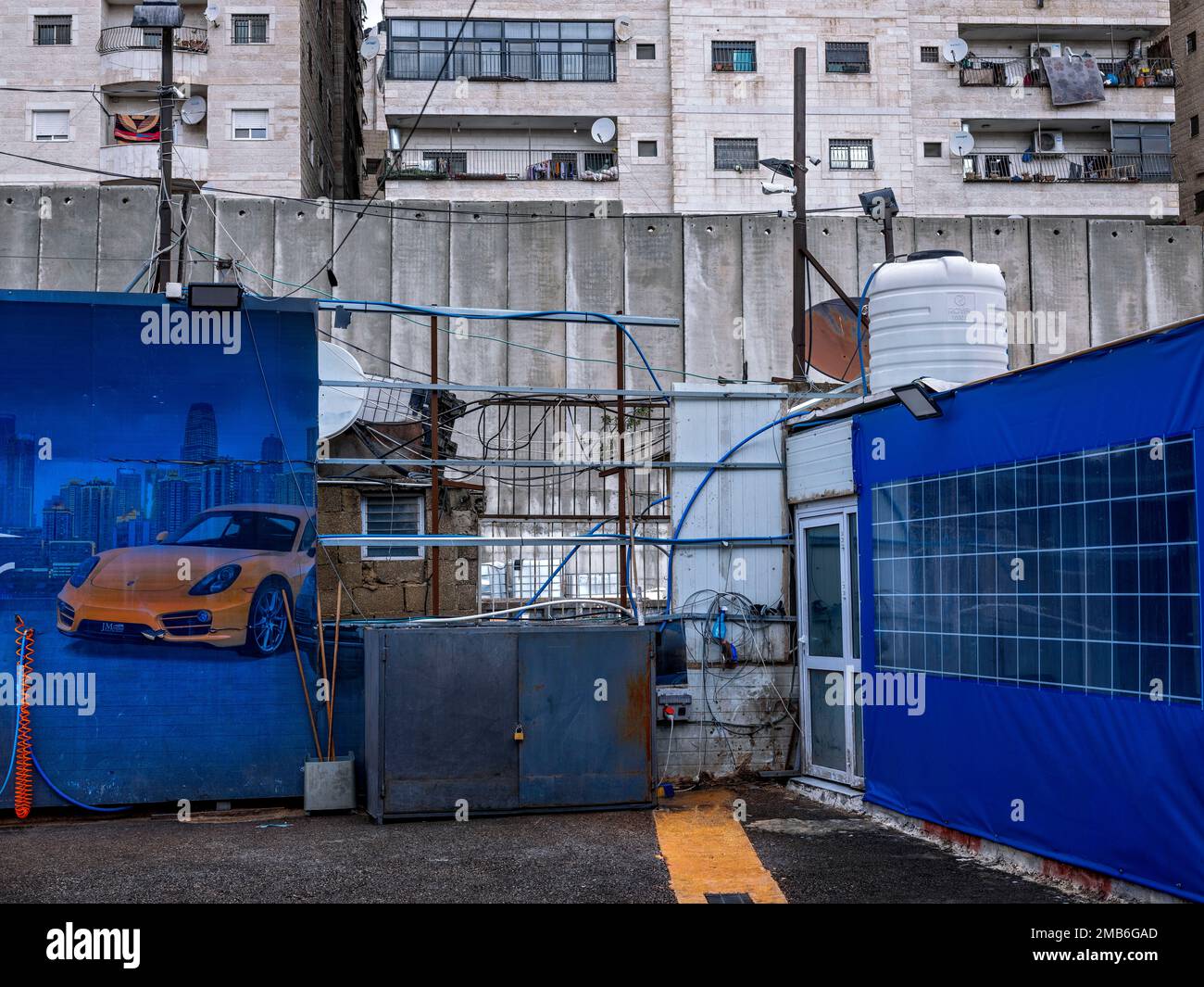 A car wash station located next to Israel's separation barrier with