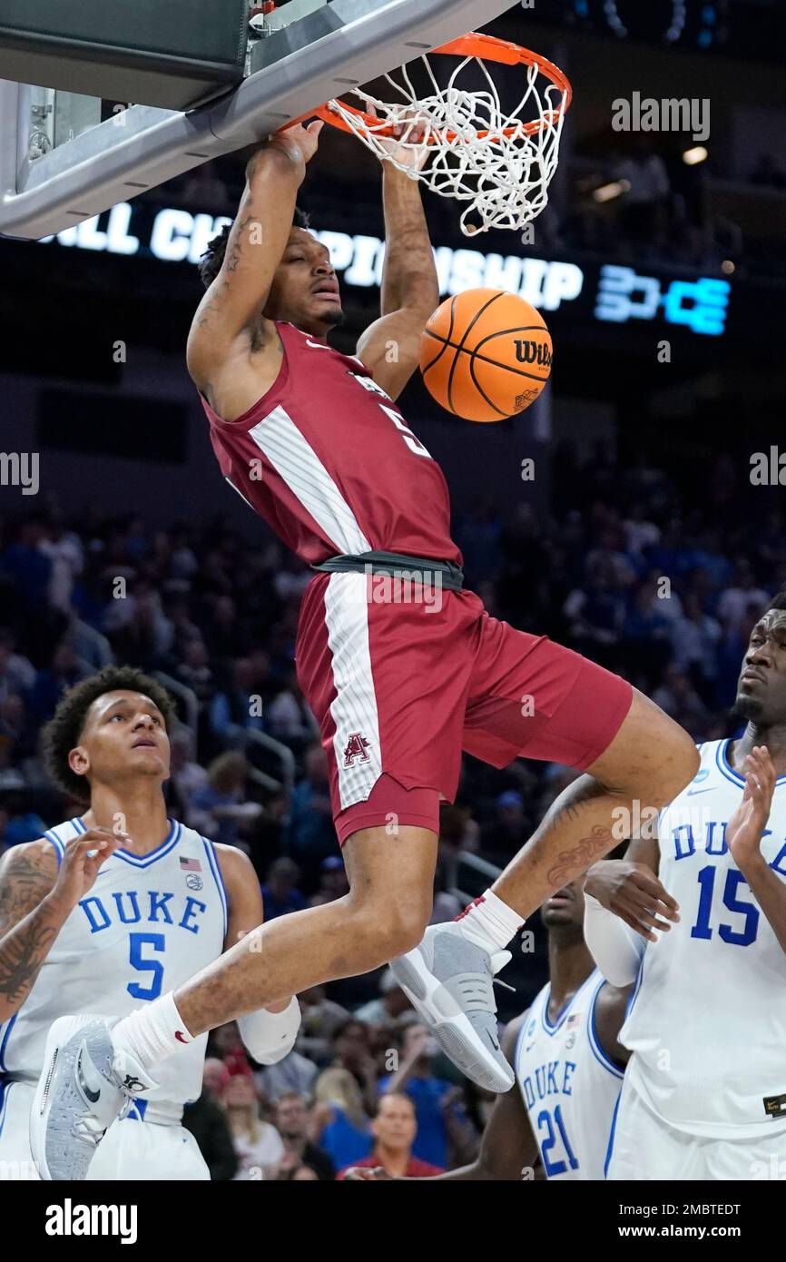 Arkansas guard Au'Diese Toney, top, dunks against Duke during the second half of a college