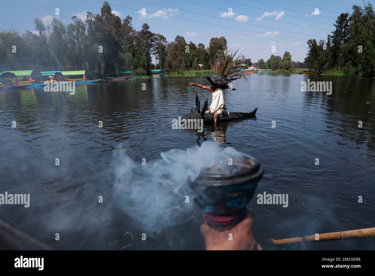 Manuel Rodriguez sits atop a canoe shaped in the form of salamander