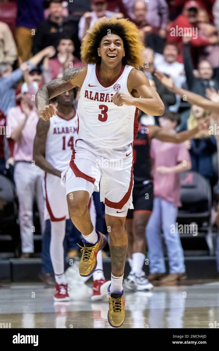 Alabama guard JD Davison (3) celebrates after dunking for the lead and