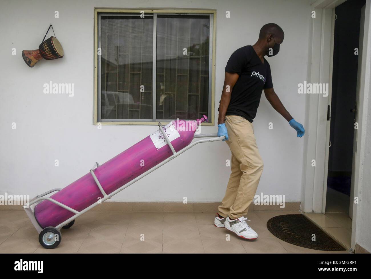 A worker from a private medical service brings oxygen bottles to aid