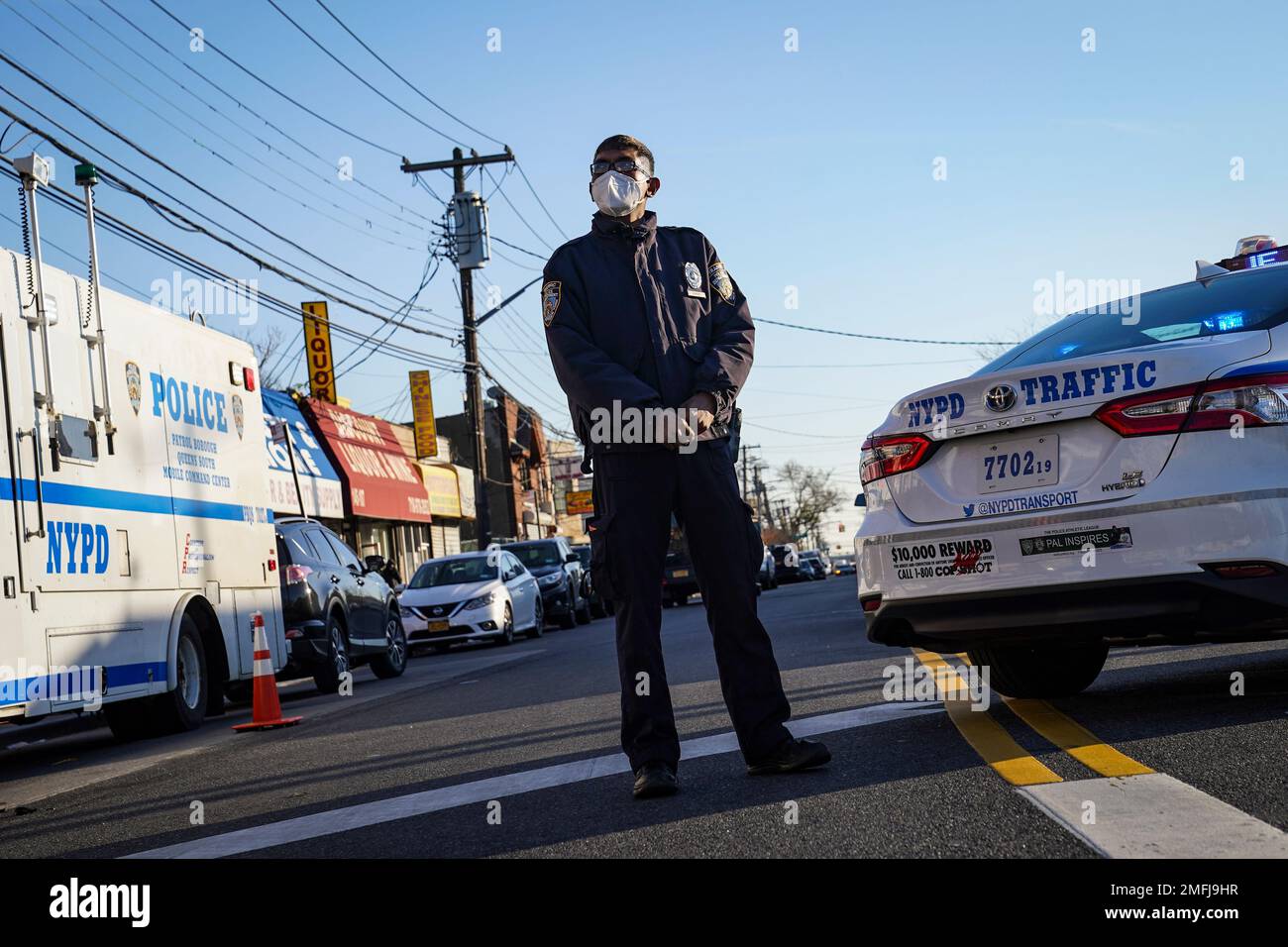 Police maintain a perimeter outside a crime scene, Tuesday, Nov. 24, 2020, in the Queens borough